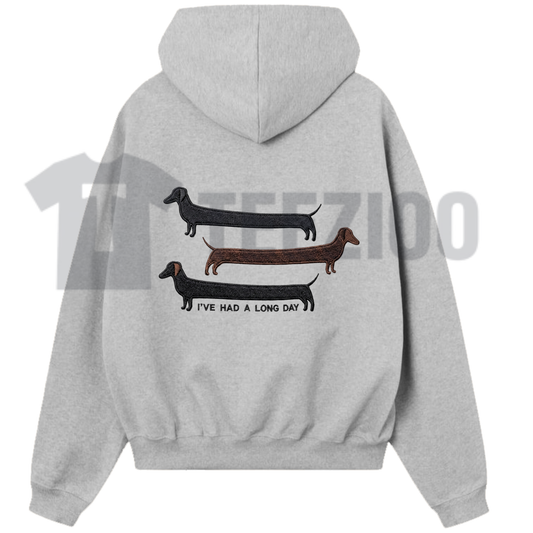 Front view of I've Had A Long Day Funny Dog Embroidered Unisex Hoodie in a cozy lifestyle setting - teezioo